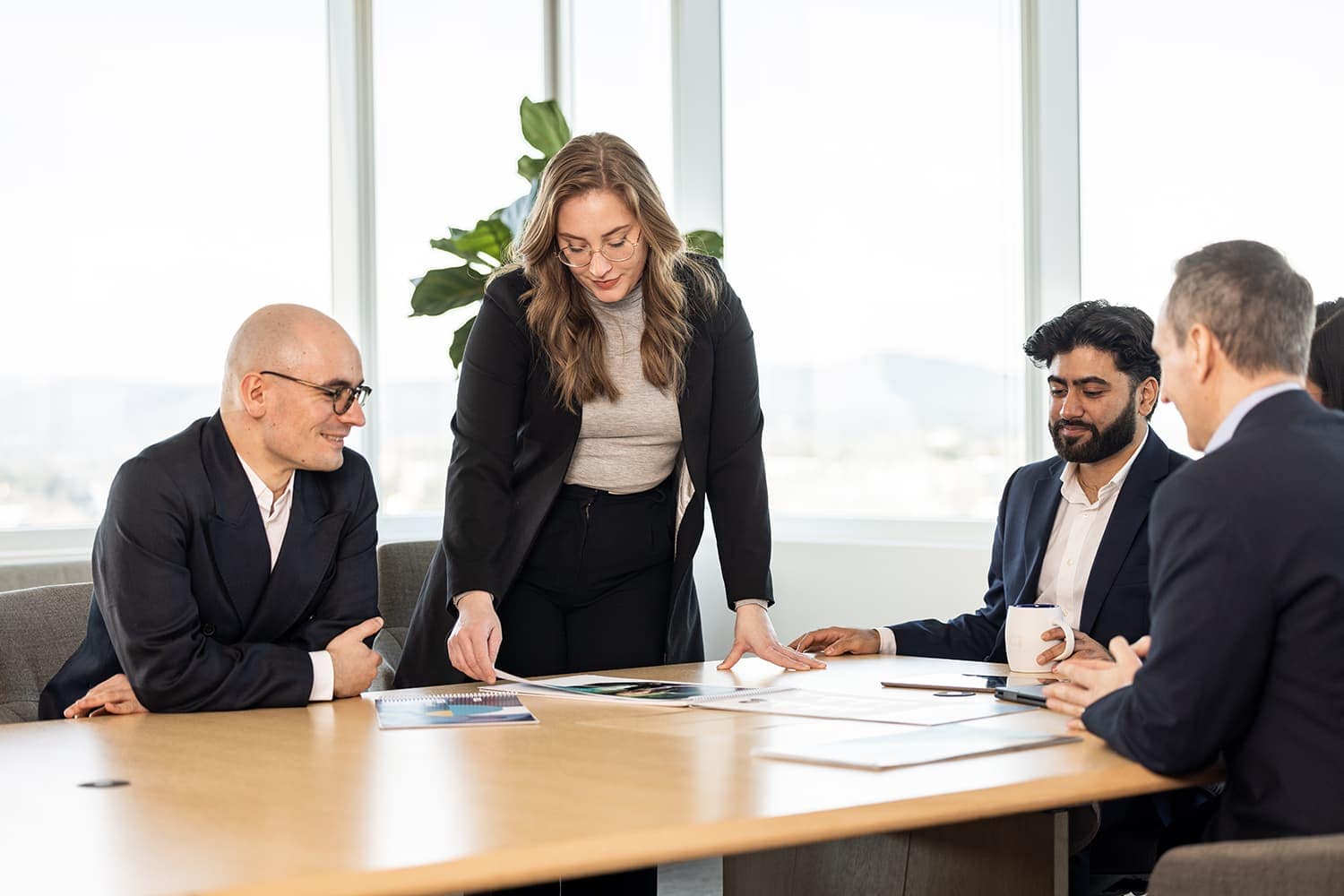 People looking over documents at a conference table People looking over documents at a conference table