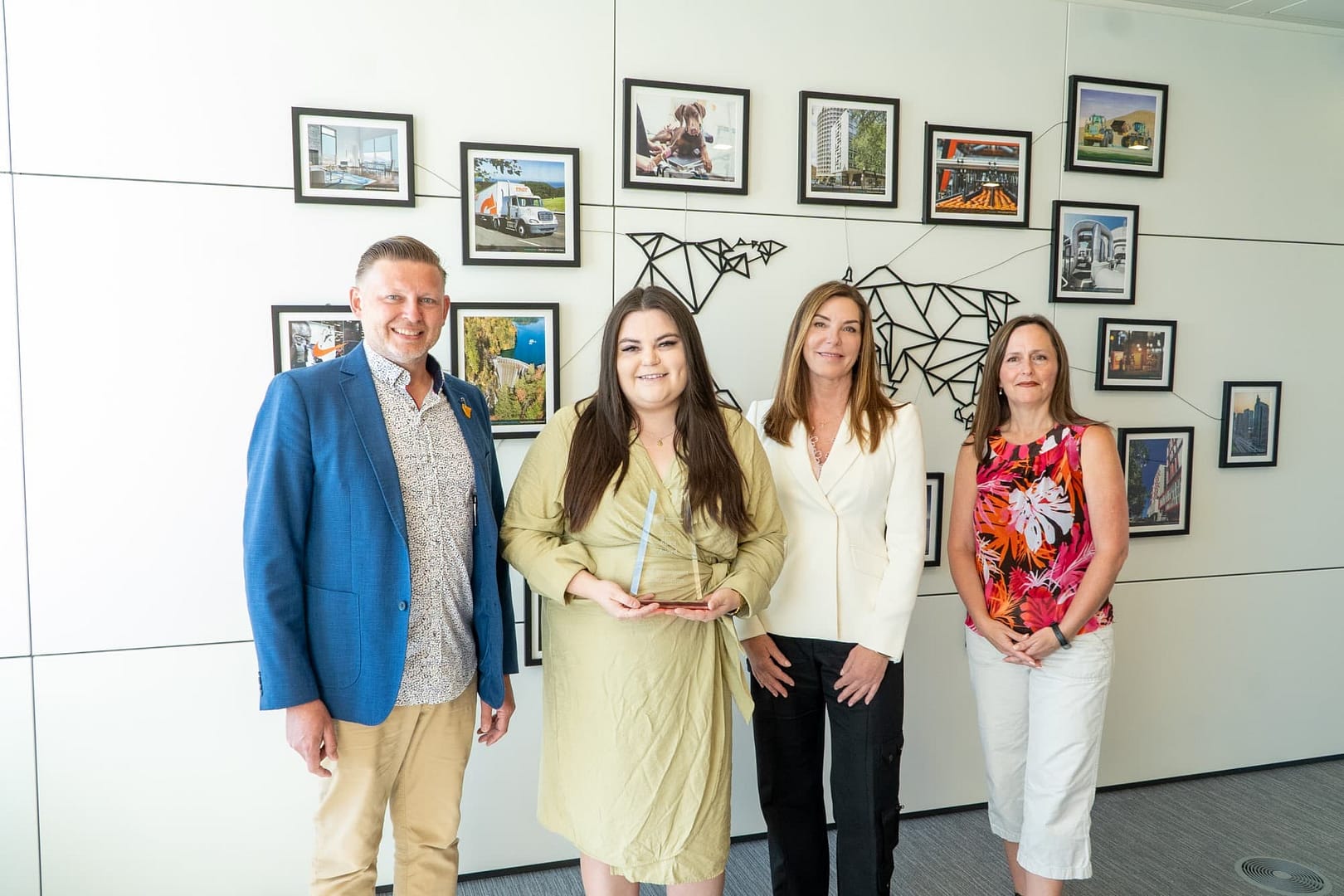 BCI's 2024 United Way Spirit Award recipients shows four people standing in front of a white wall with many framed photos on it. BCI's 2024 United Way Spirit Award recipients shows four people standing in front of a white wall with many framed photos on it.