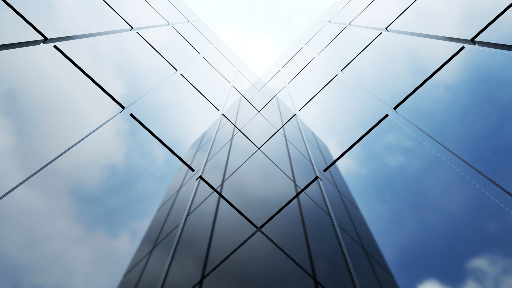 Image looking up at the outside corner where two mirrored building panels meet. Image looking up at the outside corner where two mirrored building panels meet.