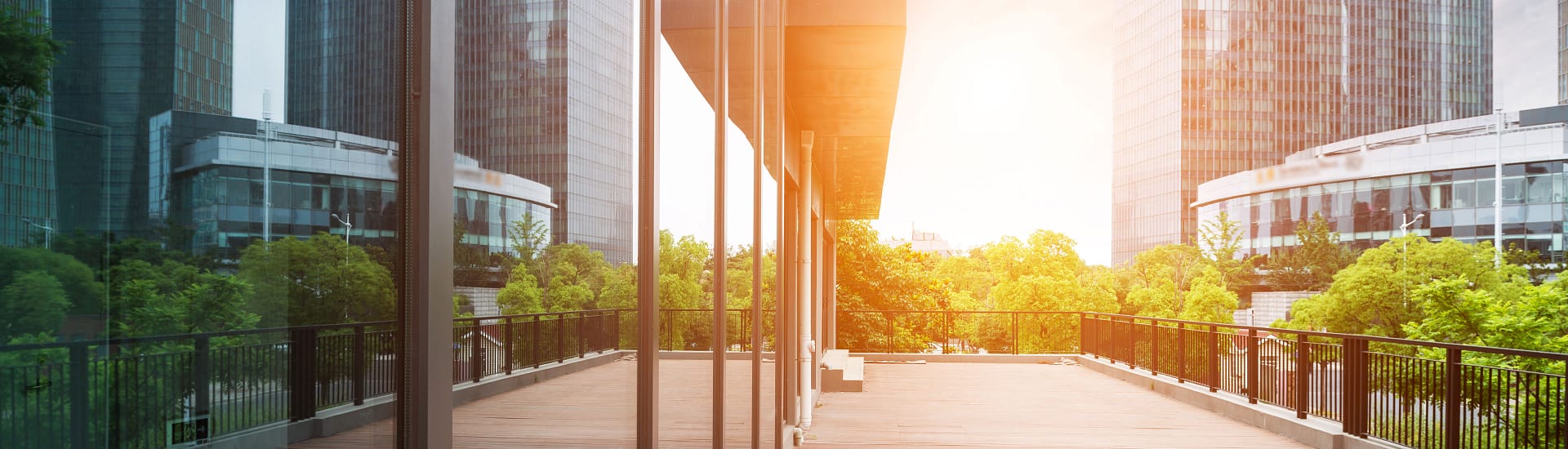 Looking at the front of an office building with large glass windows. Looking at the front of an office building with large glass windows.