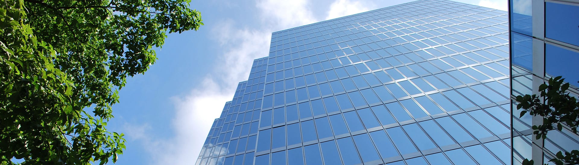 Looking up on a high-rise building with large glass windows. Looking up on a high-rise building with large glass windows.