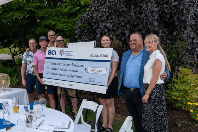 BCI charity golf tournament participants holding a $400,000 donation cheque BCI charity golf tournament participants holding a $400,000 donation cheque