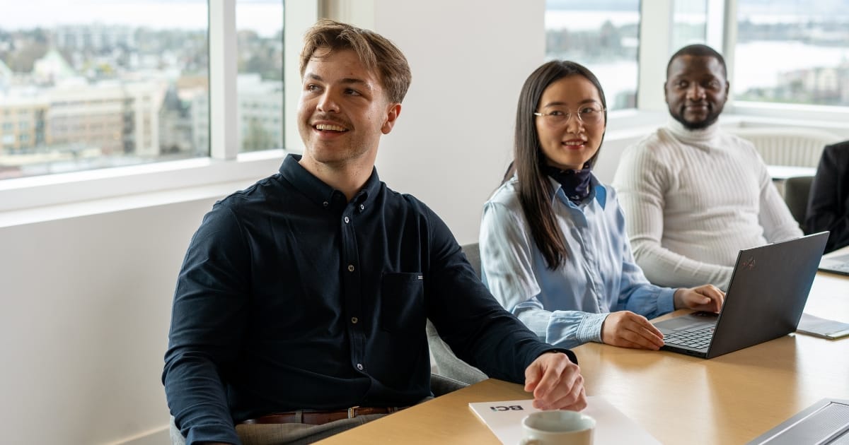 three BCI Interns meeting in a boardroom three BCI Interns meeting in a boardroom