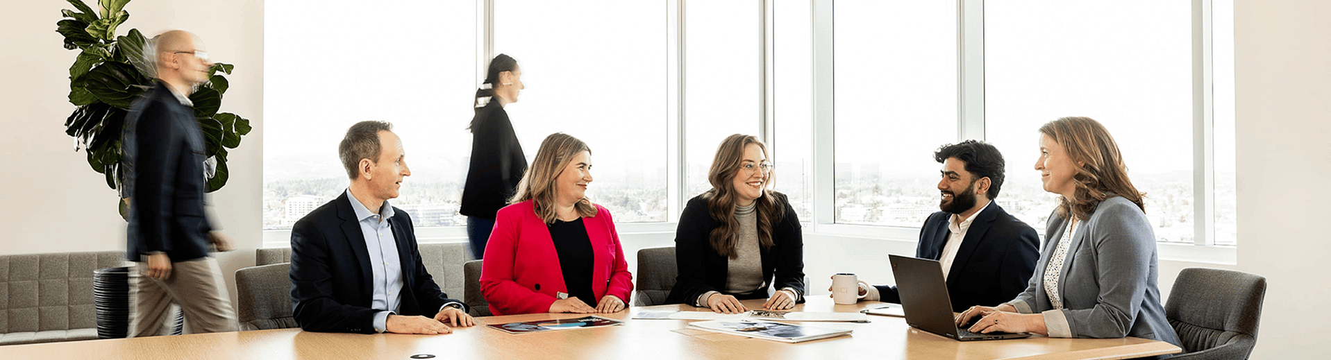Group of coworkers sitting around a conference table Group of coworkers sitting around a conference table